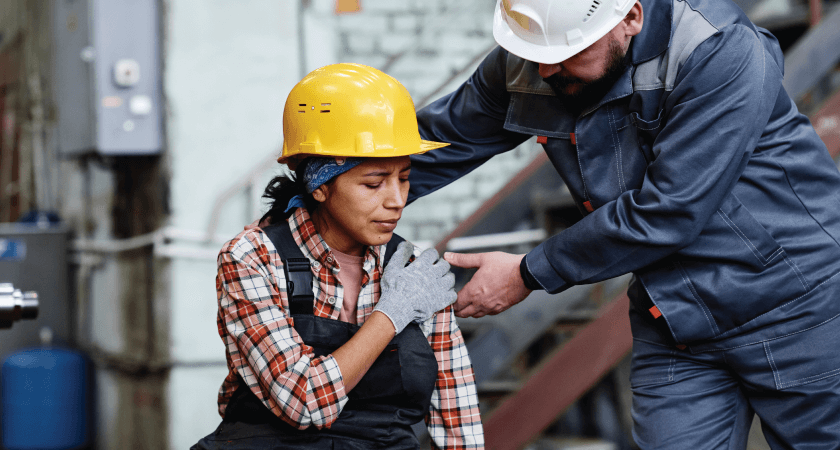 A construction worker indicates shoulder pain